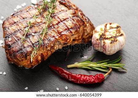 Cooked steak marble grilled meat with spices. Photo for menu, space for text