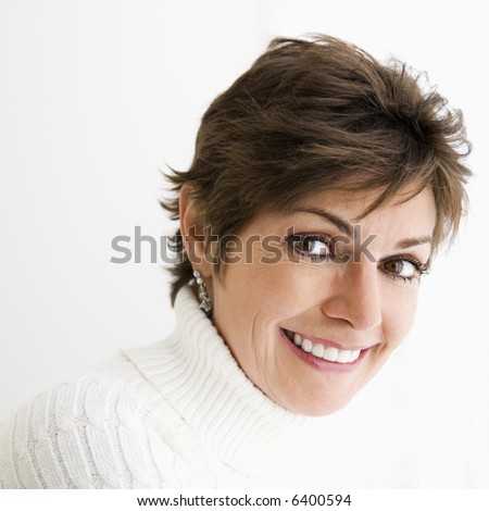 Head and shoulder portrait of pretty Caucasian woman smiling.