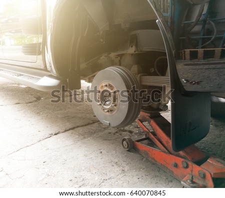 Changing the tire with car-jack.