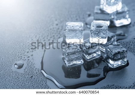 Ice cubes over dark background