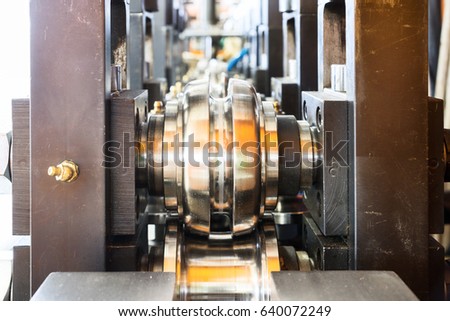 Steel round rollers for rolling wire. Fragment Wire drawing equipment. Abstract industrial background. Royalty-Free Stock Photo #640072249