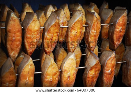 The process of smoking fish (halibut) in a mobile smoking shed. Selective focus.