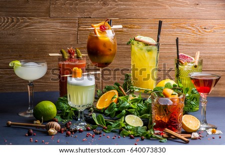 Different cocktails and ingredients for them on the background of boards Royalty-Free Stock Photo #640073830