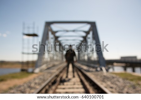 Blurred background with human silhouette on railroad bridge