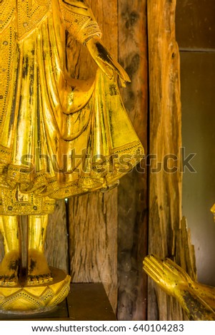 Golden Buddha  under the wood roof, spectacular beautiful and  adorably respectful.