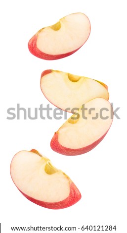 Isolated flying apple wedges. Four falling pieces of red apple fruit isolated on white background