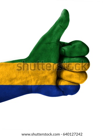 Hand making thumbs up sign.Gabon painted with flag as symbol of thumbs like,up,okay. Isolated on white background.