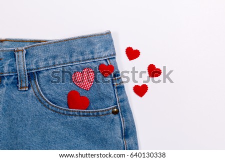 Isolated blue jeans with lovely red heart on white background