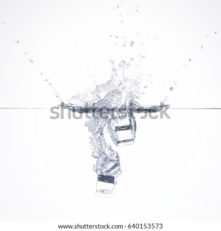 ice cube falling into water on white background