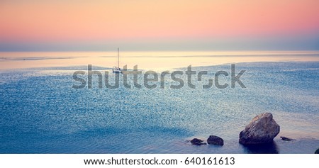 sailboat in sea water at sunrise, panoramic photo