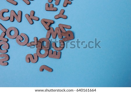 Set of a wooden letters of the English alphabet on wooden blue background