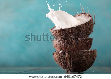 Coconut and coconut vegan milk non dairy on blue background with copy space