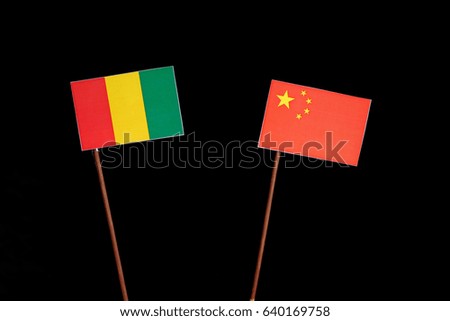 Guinean flag with Chinese flag isolated on black background