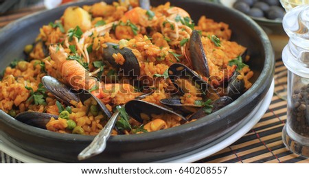Close up view of delicious Spanish seafood paella: mussels, king prawns, langoustine, haddock Royalty-Free Stock Photo #640208557