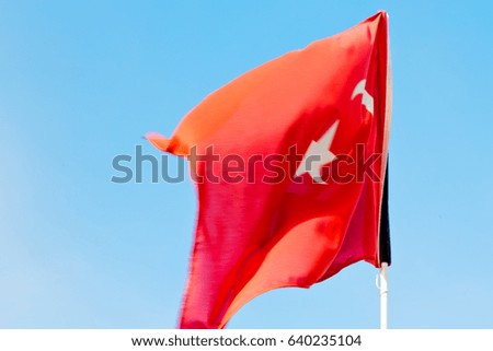 waving flag in the blue sky  tunisia     colour and wave