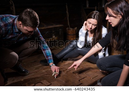 Young people trying to solve a conundrum to get out of the trap, escape the room game concept Royalty-Free Stock Photo #640243435
