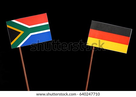 South African flag with German flag isolated on black background