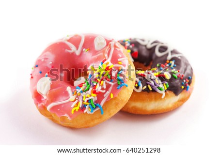 Donut with colorful sprinkles isolated on white.