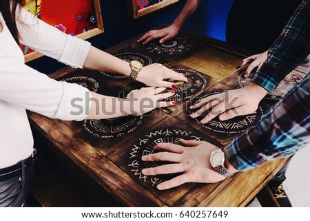The hands of young people move pieces of the Mexican style trying to get out of the trap, escape the room game concept Royalty-Free Stock Photo #640257649