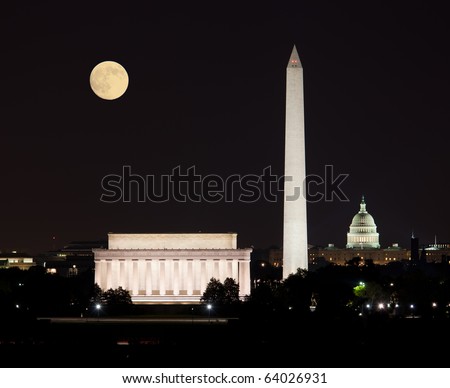 Full Harvest moon rising above the Lincoln Memorial with Washington Monument and Capitol building aligned