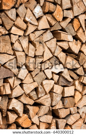 Fire wood natural background texture, chopped firewood vertical image