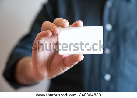 Hand holding blank white credit card mockup front side view. Plastic bank-card design mock up 