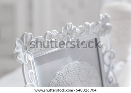 shabby chic room interior. Wedding decor, room decorated for shabby chic rustic wedding, with bedside table, folding screen or room divider with white tracery and rose bouquets. High key