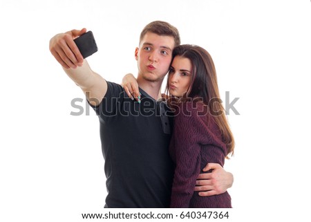young guy and his cute girl make pics on phone