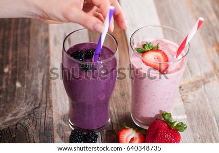 Healthy Eating. Berry smoothies, milkshakes made with fresh blueberries and strawberries in a glass 
