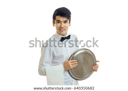 cheerful brunette waiter man in uniform with tray in his hands smiling