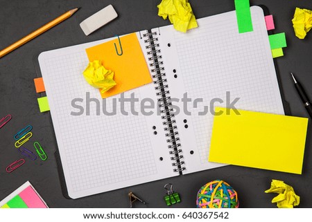 Open notepad with office supplies
