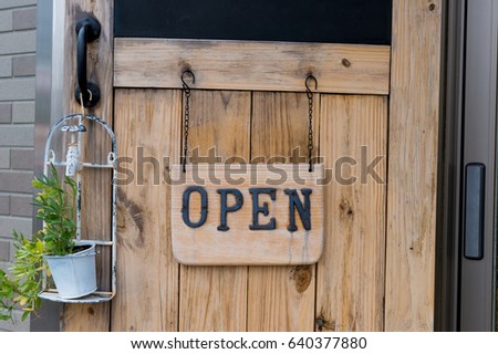 Vintage open sign on old wooden door