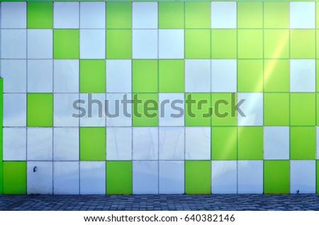 The texture of the metal wall, framed in the form of colored squares of two colors. Modern wall design for the exterior of residential and office buildings