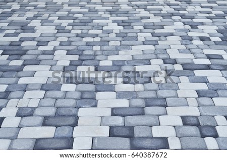 A detailed photo of the square, laid out of modern paving stone with rounded corners. Accurate design of pedestrian areas