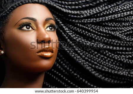 Close up cosmetic beauty portrait of african woman showing long black braided hairstyle. Royalty-Free Stock Photo #640399954