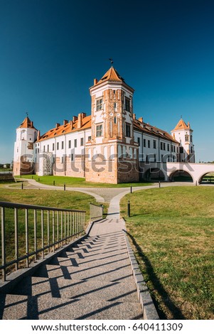 Mir, Belarus. View Of Old Towers Of Mir Castle Complex On Blue Sunny Sky Background. Architectural Ensemble Of Feudalism, Ancient Cultural Monument, UNESCO Heritage. Famous Landmark In Summer