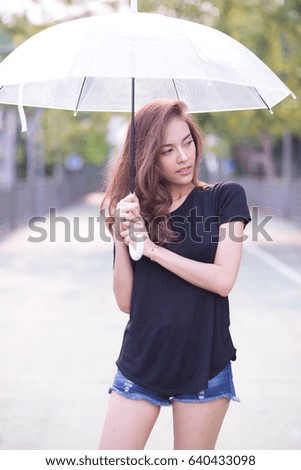 beautiful asian woman in black t-shirt and umbrella on hand