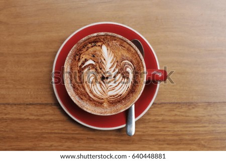 Top view of hot cappuccino on wooden background