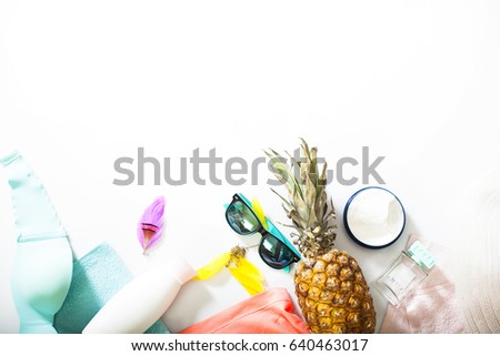 Summer concept with pineapple and essentials of traveler, Vacation background with beach items on wood table