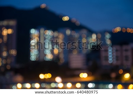 Abstract blur seaside night cityscape in twilight evening background