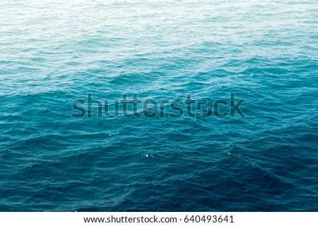 Deep blue sea water wave suface texture and background with sun reflection.