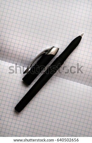 Open the notebook in a cage on a wooden table with a handle. Open the laptop on your desktop. Open notebook / diary with pen. Close-up photo. Business concept, place for text