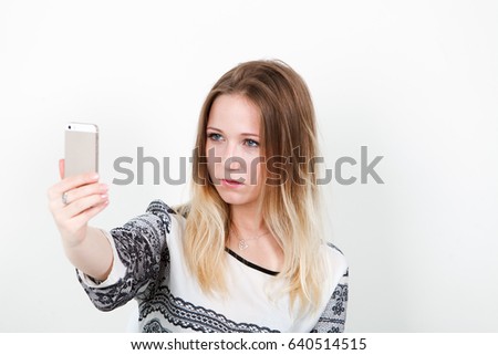 Girl office worker doing selfie at work. On a white background