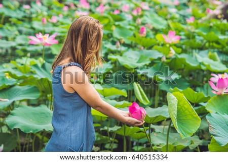 picture of beautiful woman Red-haired with lotus flower in hand.