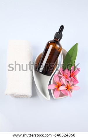 massage oil with pink frangipani flowers