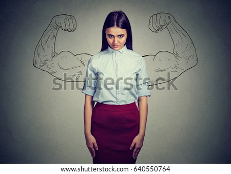 powerful girl reality vs ambition wishful thinking concept. Sad woman looking at camera isolated on gray wall background 