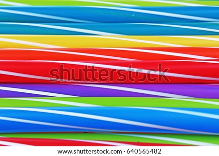 Fancy straw art background. Abstract wallpaper of colored fancy straws. Rainbow colored colorful pattern texture. Party accesorries.