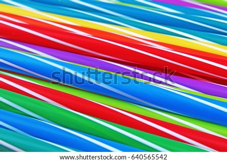Fancy straw art background. Abstract wallpaper of colored fancy straws. Rainbow colored colorful pattern texture. Party accesorries.