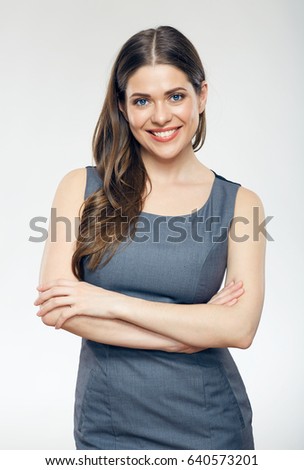 Smiling business woman isolated portrait with crossed arms wearing gray dress.