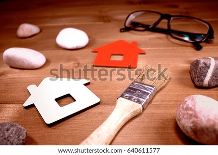 Sign Home, brush, glasses and stones - concept of building or repairing houses